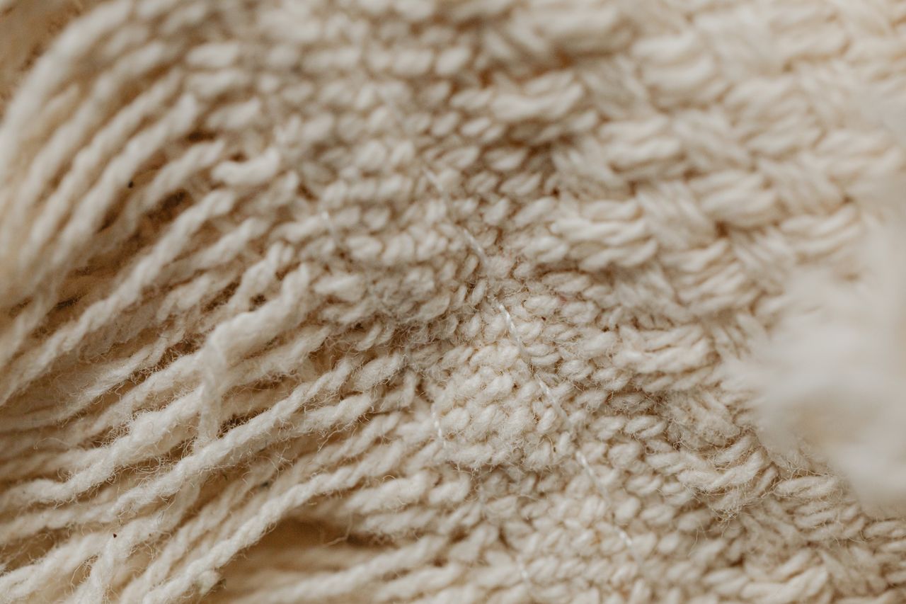 Detailed close-up of a woven textile fabric showing intricate patterns and texture.